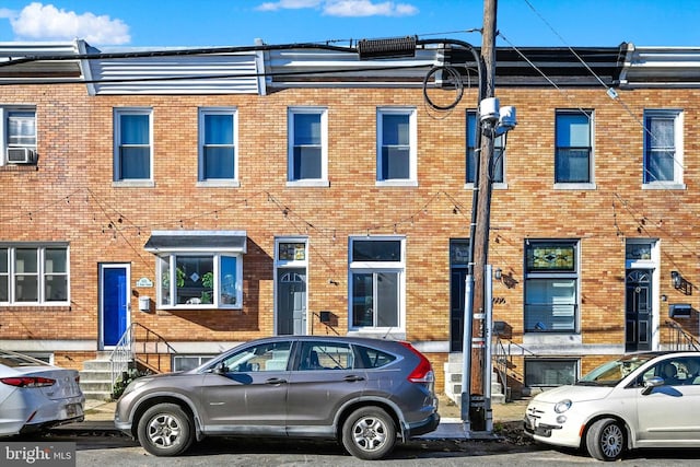 view of front of home featuring entry steps, brick siding, and cooling unit