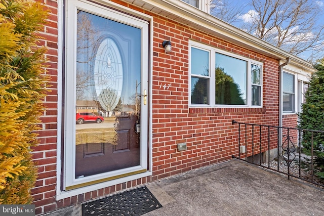 entrance to property with brick siding