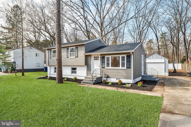 split level home with an outbuilding, a garage, driveway, crawl space, and a front yard