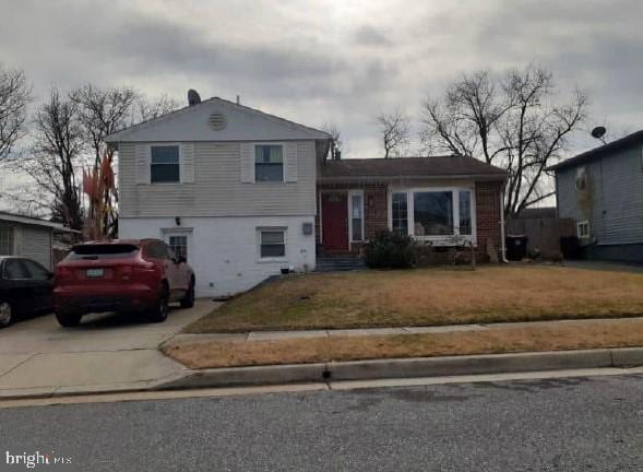 split level home featuring a front yard and driveway