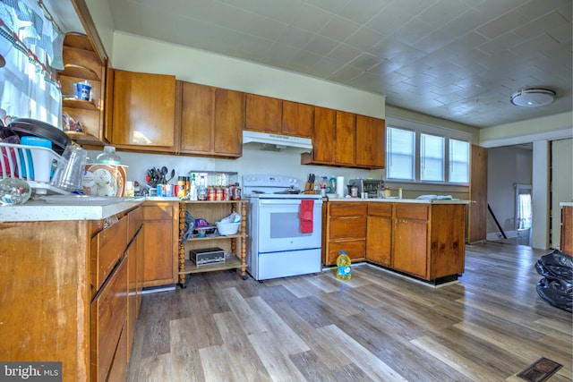 kitchen with open shelves, white electric range oven, light wood-style flooring, brown cabinetry, and under cabinet range hood