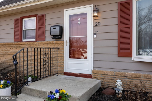 doorway to property with brick siding