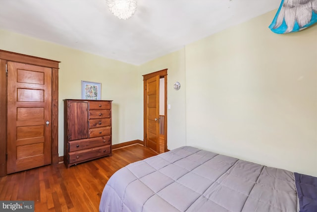 bedroom featuring wood finished floors and baseboards