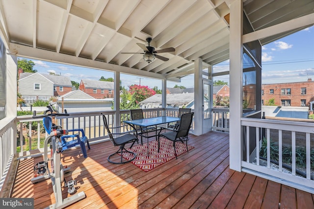 wooden deck with outdoor dining area and a ceiling fan