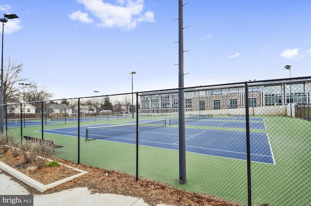 view of tennis court featuring fence