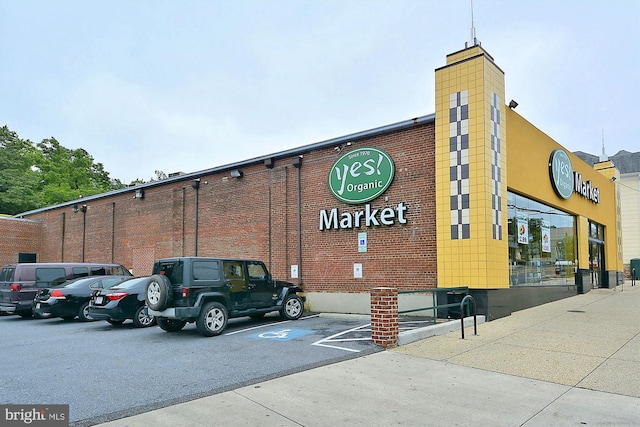 view of building exterior with uncovered parking