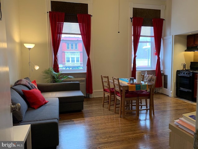 dining room featuring radiator heating unit and wood finished floors