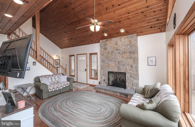 living area with a ceiling fan, wood ceiling, wood finished floors, and stairs