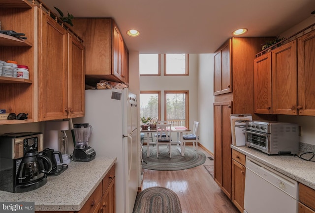 kitchen with white appliances, brown cabinetry, light wood finished floors, open shelves, and recessed lighting