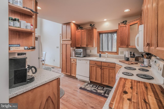 kitchen featuring white appliances, open shelves, recessed lighting, a sink, and light wood-type flooring