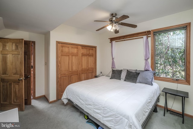 carpeted bedroom featuring a closet, a ceiling fan, and baseboards