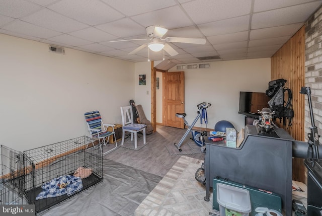 interior space with visible vents, wood finished floors, a ceiling fan, and a drop ceiling