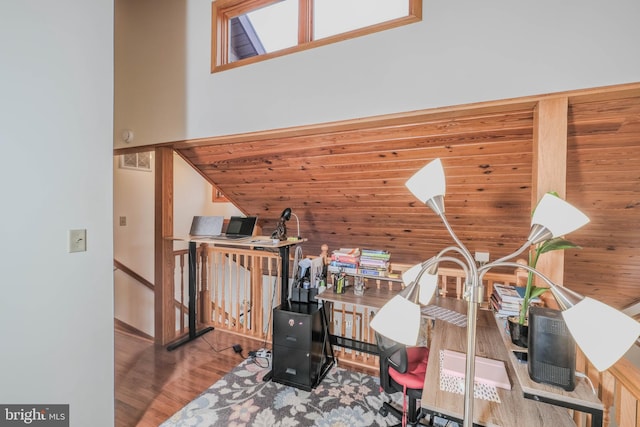 office with wood finished floors, visible vents, and high vaulted ceiling