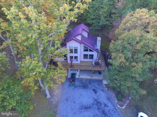 drone / aerial view featuring a wooded view