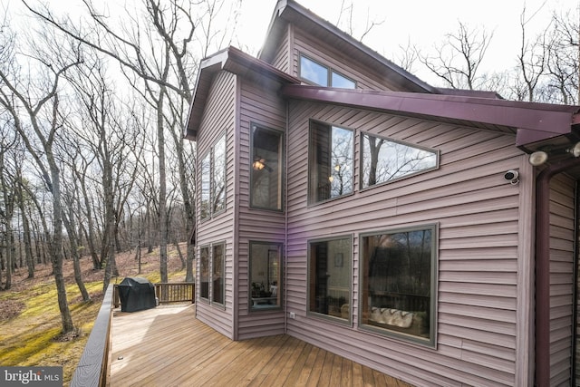 wooden terrace with a grill