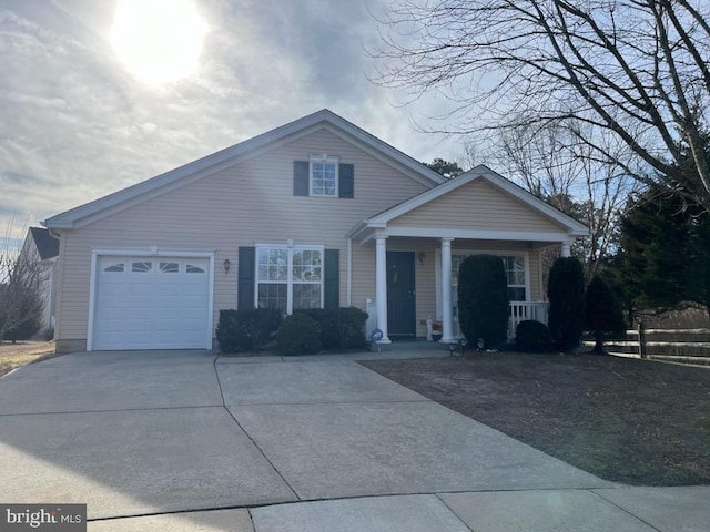 view of front facade featuring an attached garage, driveway, and a porch