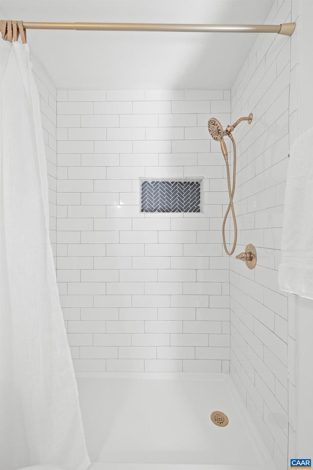 full bathroom with a tile shower