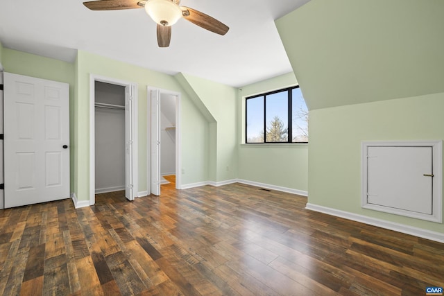 unfurnished bedroom featuring ceiling fan, visible vents, baseboards, and hardwood / wood-style floors