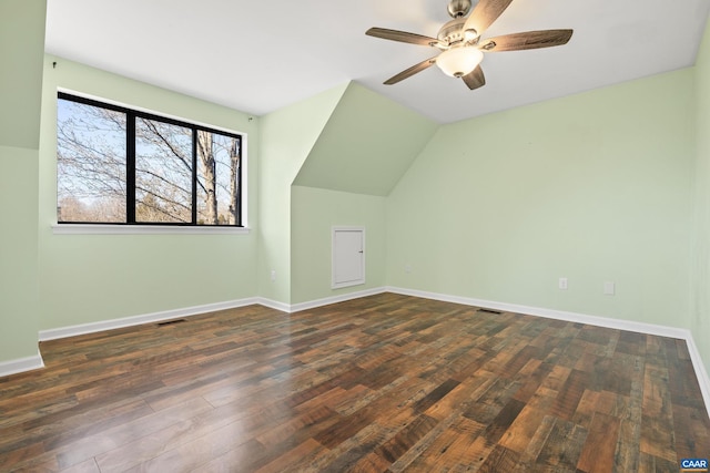 bonus room featuring baseboards, visible vents, a ceiling fan, wood finished floors, and vaulted ceiling