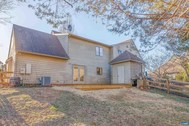 rear view of house with french doors, roof with shingles, fence, a wooden deck, and central air condition unit