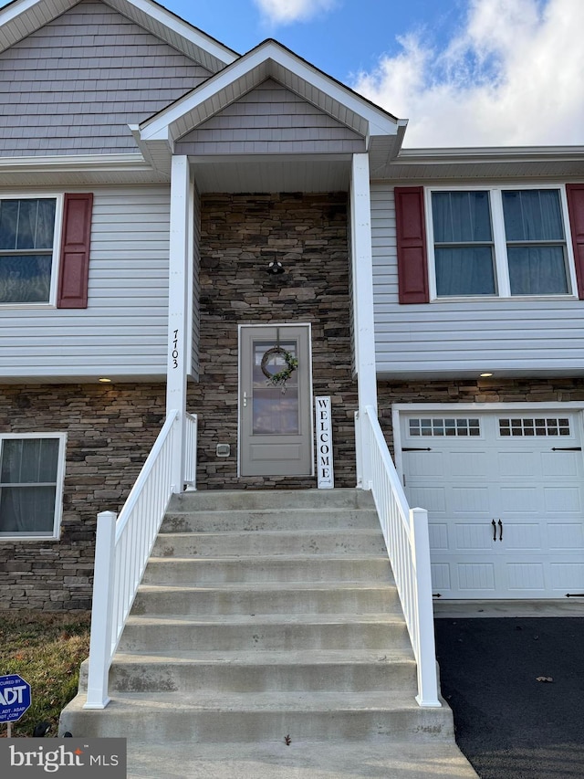 view of front of house featuring stone siding and an attached garage