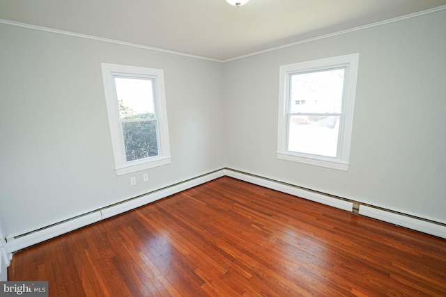 spare room featuring a baseboard heating unit, crown molding, and hardwood / wood-style flooring