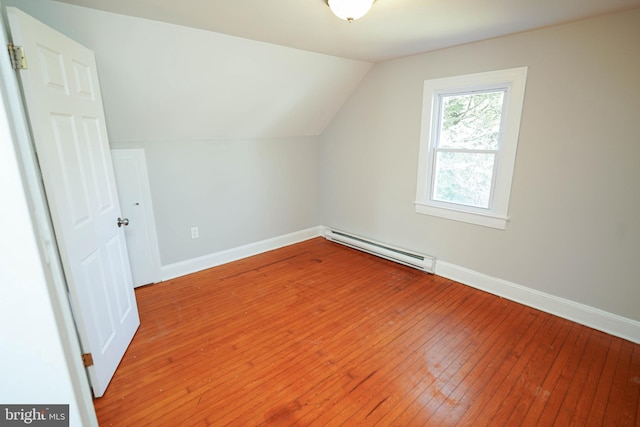 bonus room with lofted ceiling, baseboards, a baseboard heating unit, and hardwood / wood-style floors