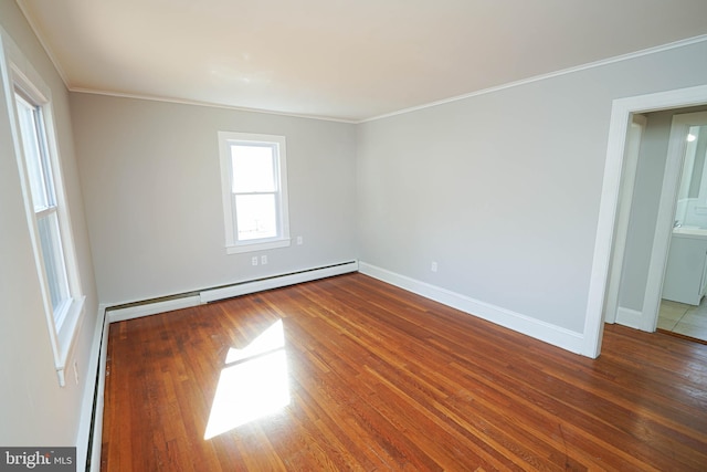 unfurnished room featuring ornamental molding, a baseboard radiator, wood finished floors, and baseboards