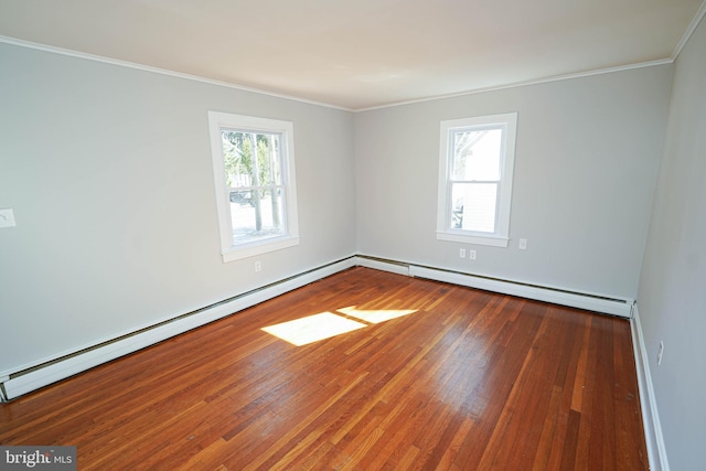 unfurnished room with hardwood / wood-style flooring, a baseboard heating unit, and crown molding