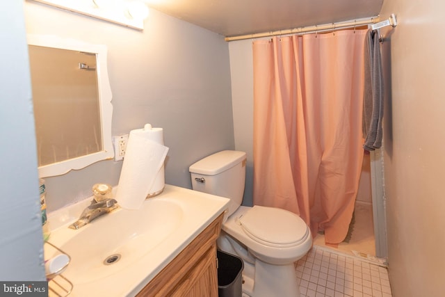 bathroom featuring curtained shower, vanity, toilet, and tile patterned floors