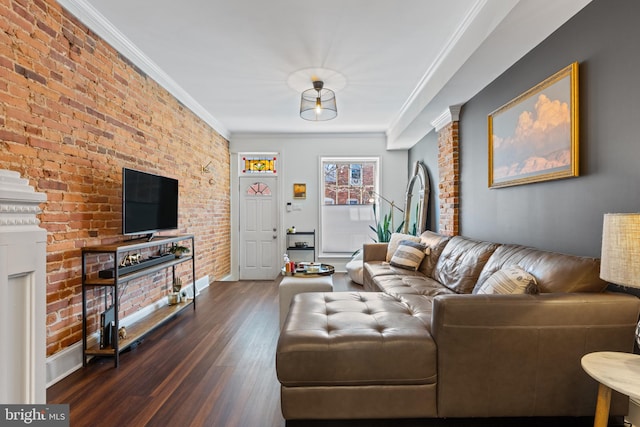 living area featuring brick wall, crown molding, and wood finished floors