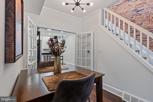 dining room with dark wood-type flooring, visible vents, baseboards, ornamental molding, and stairway