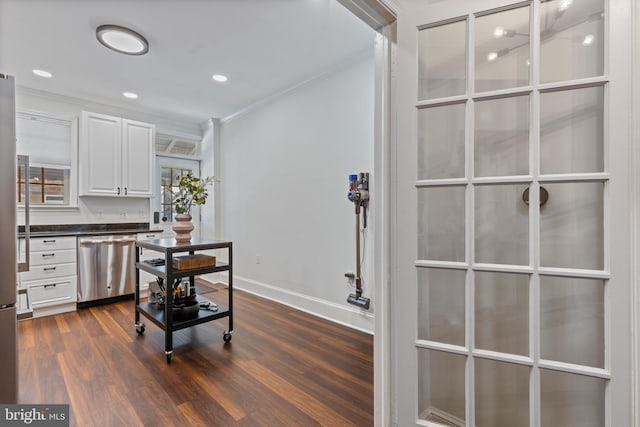 office space featuring baseboards, dark wood-type flooring, crown molding, and recessed lighting