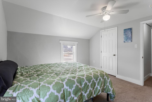 carpeted bedroom with lofted ceiling, a ceiling fan, and baseboards