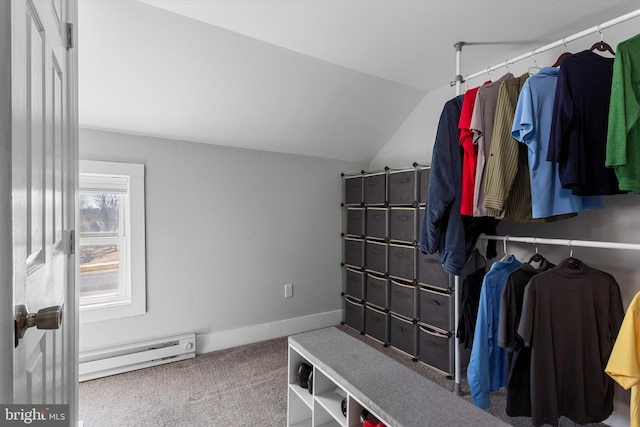 walk in closet featuring a baseboard heating unit, vaulted ceiling, and carpet