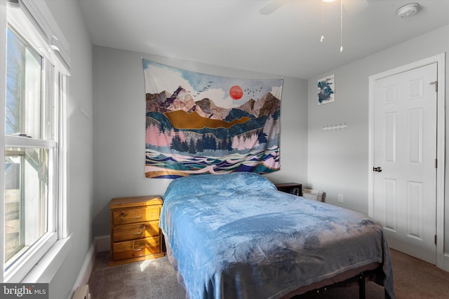 bedroom with a ceiling fan and carpet flooring