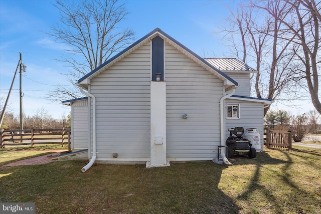 exterior space featuring a lawn and fence