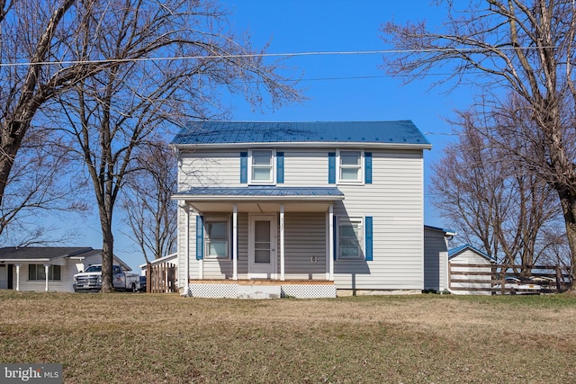 view of front of property featuring metal roof, a porch, and a front yard