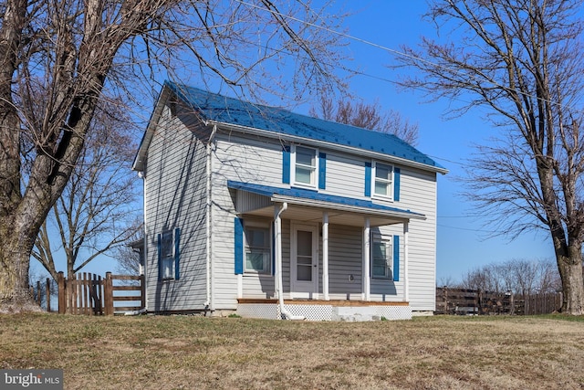 view of front of property with a porch, a front yard, and fence