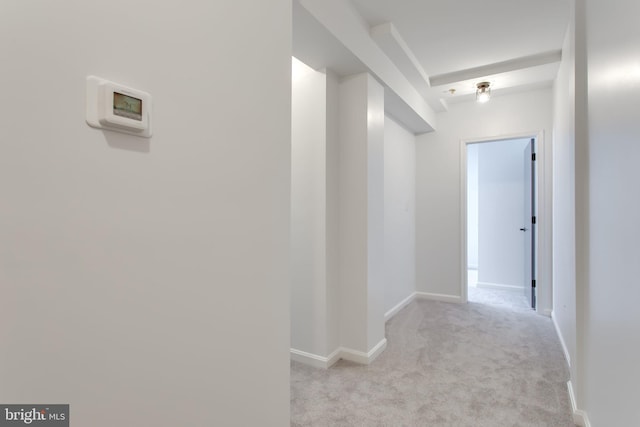 hallway with light carpet and baseboards