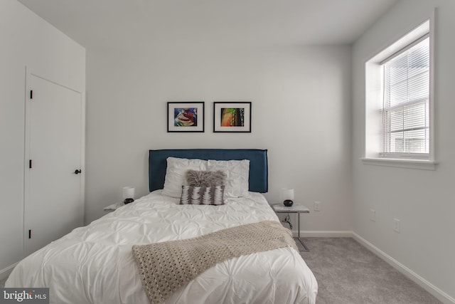 carpeted bedroom with baseboards