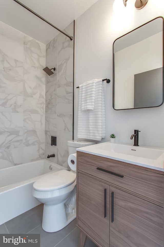bathroom with washtub / shower combination, vanity, and toilet