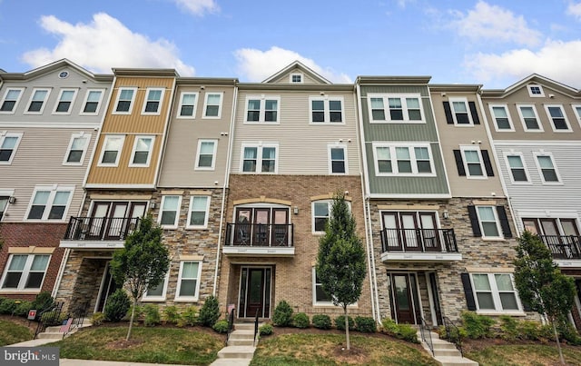 townhome / multi-family property with stone siding