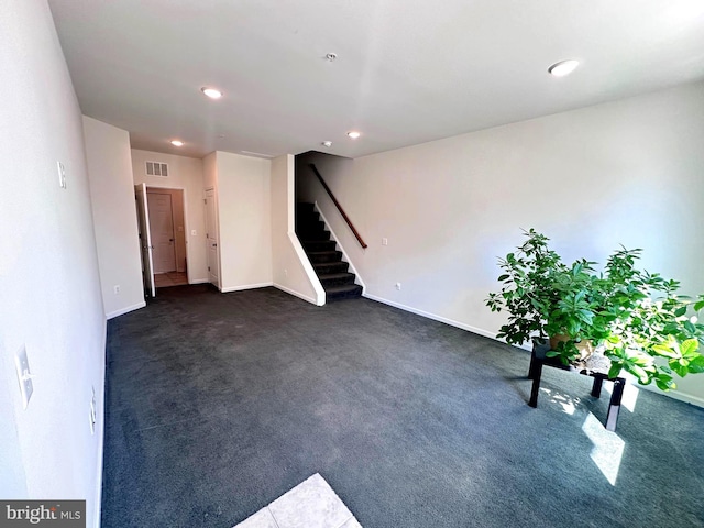 interior space with visible vents, recessed lighting, stairway, dark colored carpet, and baseboards