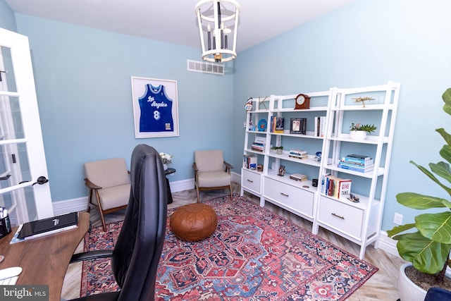 office featuring wood finished floors, visible vents, and baseboards
