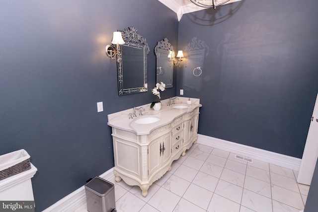 bathroom featuring baseboards, visible vents, marble finish floor, and a sink