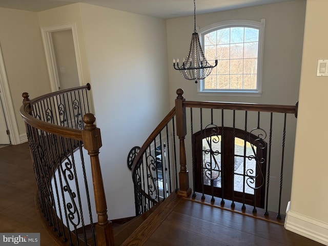 foyer featuring an inviting chandelier and wood finished floors