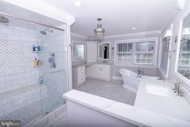 bathroom with crown molding, a freestanding tub, a stall shower, and a sink