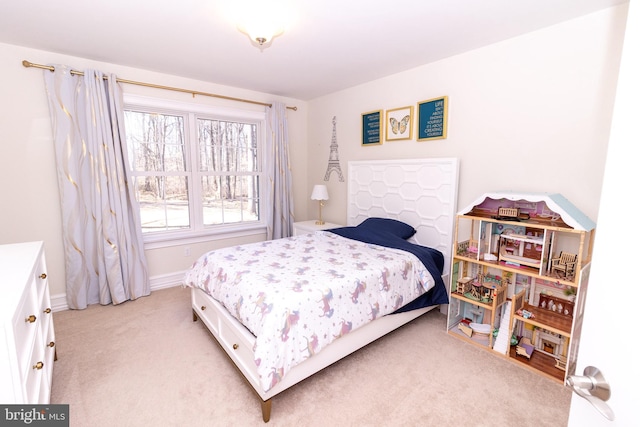 bedroom with light carpet and baseboards