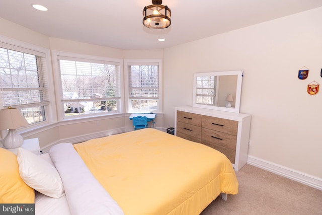 bedroom with recessed lighting, light colored carpet, and baseboards